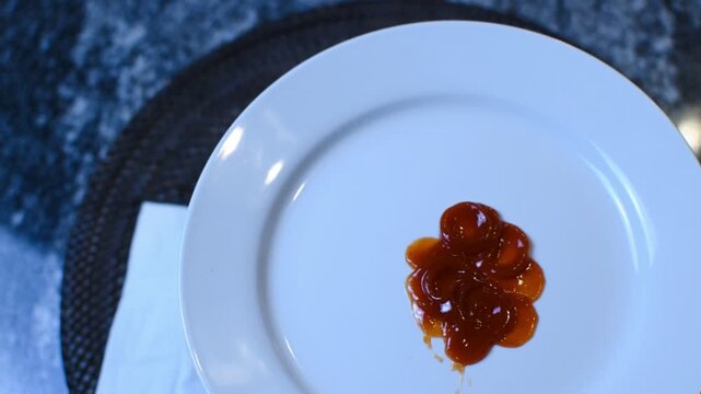 Plate of ketchup droplets.