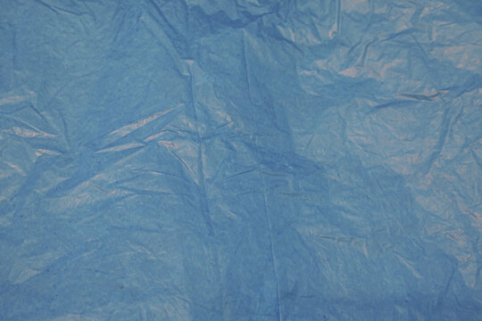 Crumpled blue plastic texture with wrinkles, ideal for background and design use