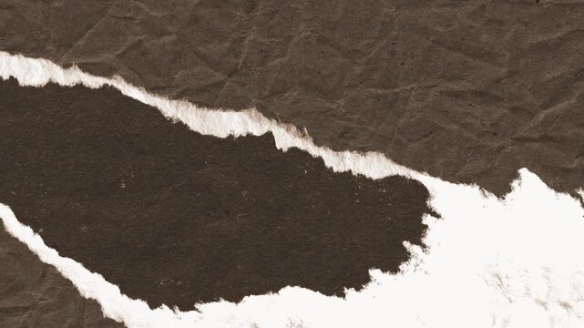 Textured brown paper being torn apart in a slow motion video animation revealing a clean white background for creative projects