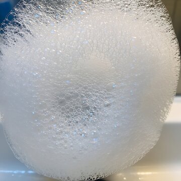 Frozen bubble on white surface closeup.