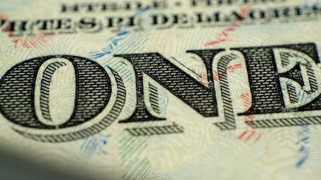 Close up of a one dollar bill showing George Washington and the word ONE.