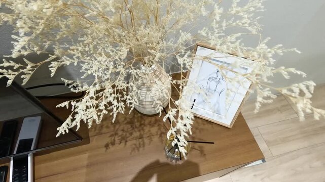 Minimalist Home Decor With Dried Flowers and Ceramic Vase on Wooden Table
