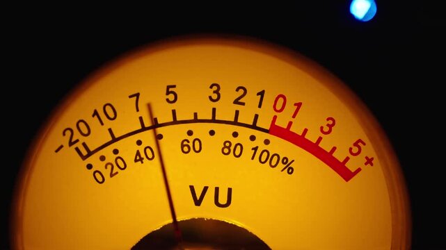 Detailed view of glowing illuminated sound level meter device used in professional audio mixing mastering studio setup copy space