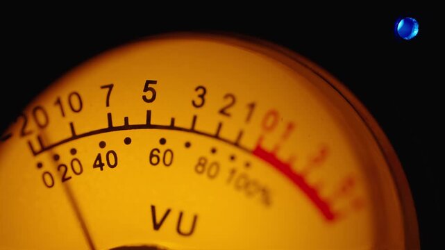 Macro shot of retro volume unit indicator scale displaying decibel signal level perfect for music production equipment backdrop concept
