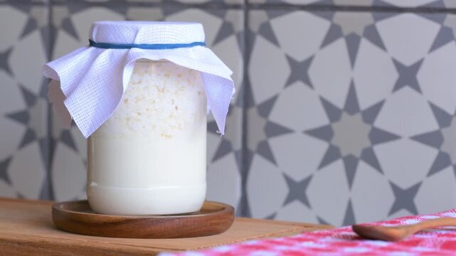 Homemade probiotic drink. Fermented milk kefir grains