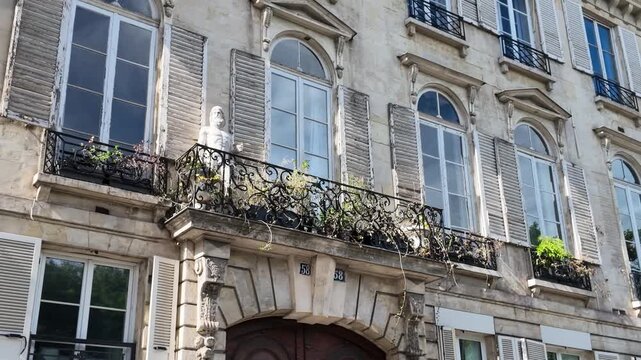 Classic Haussmann Architecture Facade with Wrought Iron Balconies in Paris