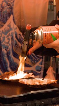 Chef Searing Fresh Scallops with Blowtorch at Tsukiji Fish Market