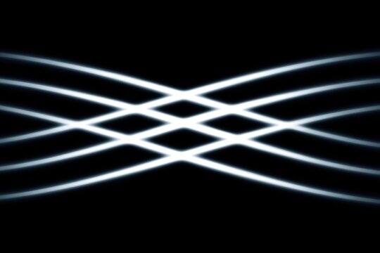 Abstract light waves intersecting in a dynamic pattern on a dark background.