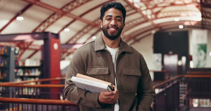 Student, face and man with books in library for thesis research, exam preparation or study material. Education, person and happy with textbooks at college for course information or academic resources