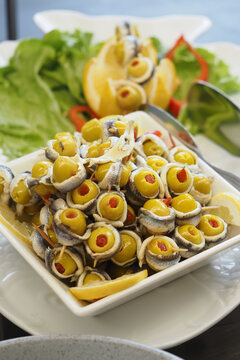 traditional Spanish appetizer is often called banderillas or gildas, consisting of pickled olives stuffed with anchovies