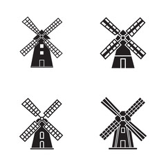 Fototapeta premium Four different simple black silhouettes of traditional windmills with rotating blades on white background for design and icons various styles and shapes
