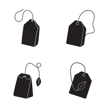 Four black tea bags with different designs on white background for beverage and food concepts