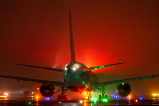 Commercial Passenger Jet Taxiing in Heavy Night Mist | Crimson Atmospheric Glow and Runway Light Reflections