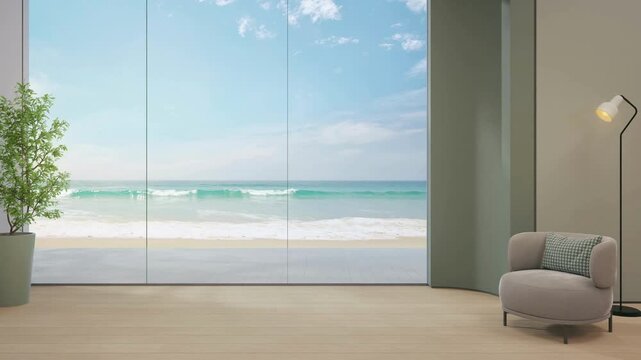 Modern living room with ocean view through large glass windows and a gray chair