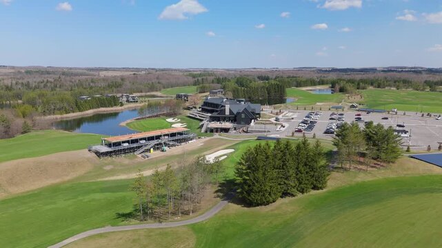 The TPC Toronto at Osprey Valley golf course features lush greens, a modern clubhouse, and ample parking. Ideal for promotional videos or travel content.
