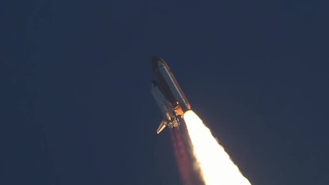 Space shuttle ascending into the sky with a massive trail of fire and smoke during launch.