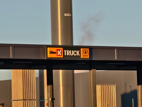 &Oslash;stfold, Norway-Nov.25th 2025: co-branded signage featuring Uno-X Truck and Preem bear logos at a gas station