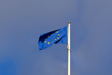 Fototapeta premium low-angle shot of the European Union flag waving on a flagpole against sky.