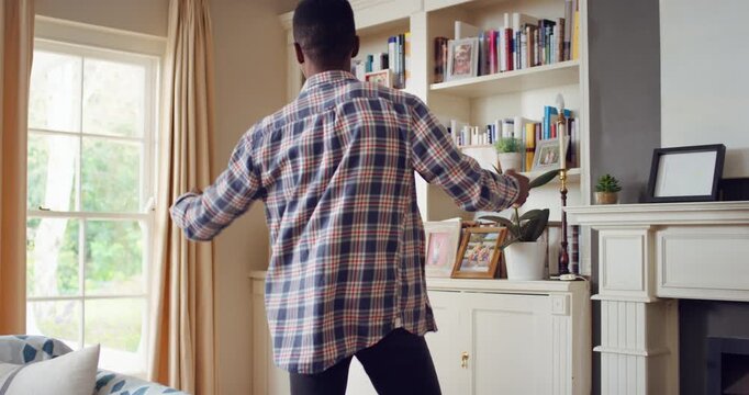 Dance, excited and black man in living room with energy for celebration, performance and expression. Dancer, movement and male person with hip hop for rhythm, entertainment and weekend fun in home