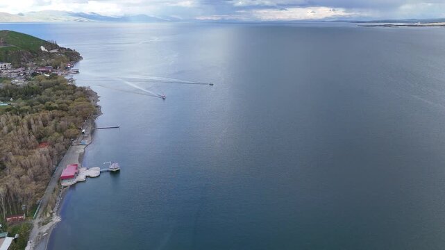 4K Drone Aerial View of Mountain Lake With Two Floating Boats and Scenic Shoreline.
