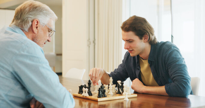 Elderly father, son and chess in house with strategy, solution or problem solving in contest for weekend. Family, boardgame and bonding with competition for thinking, knowledge or challenge in home