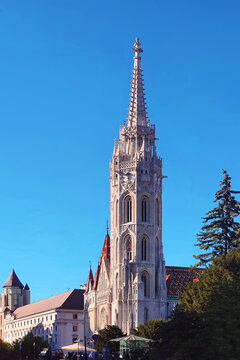 Stunning view of Matthias Church spire a famous Gothic cathedral and historical landmark in the Castle District of Budapest Hungary against a clear blue sky