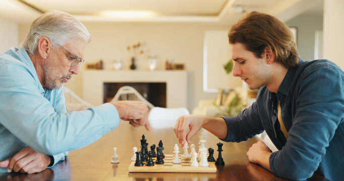 Elderly father, son and chess in home with strategy, solution or problem solving in contest for weekend. Family, boardgame and bonding with competition for thinking, knowledge or challenge in house