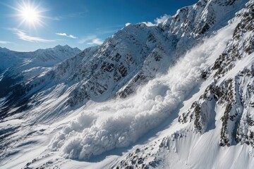 Fototapeta premium Massive snow avalanche rushing down steep alpine mountains under bright winter sun with dramatic powder clouds in remote frozen wilderness landscape