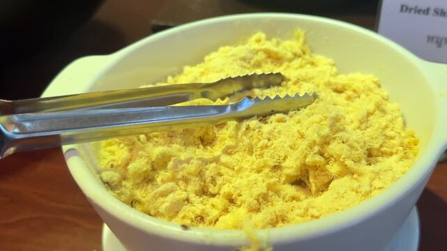 Close up video of dried shredded pork with fluffy texture and rich savory flavor for meals