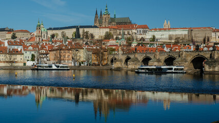 Fototapeta premium Experience the enchanting skyline of Prague featuring its iconic landmarks by the Vltava River. The historic architecture and serene waters create a perfect setting for travel and exploration.