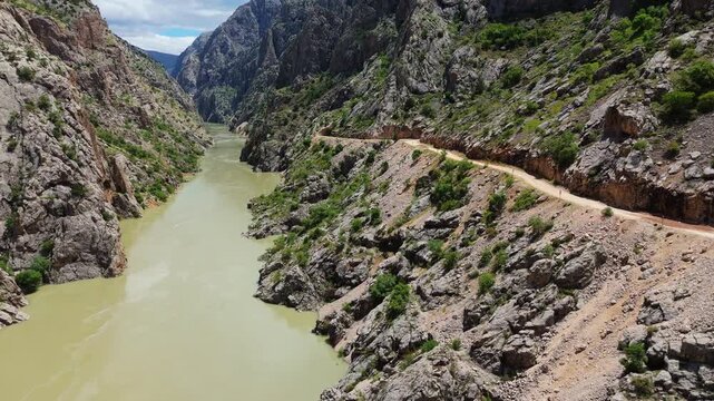Drone shot following the path of the Karasu River with the legendary hand-carved Stone Road Canyon in Kemaliye, Turkey.
