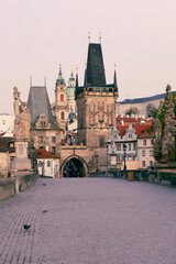 Fototapeta premium empty Charles Bridge in Prague, Czechia, admiring the gothic towers and statues.
