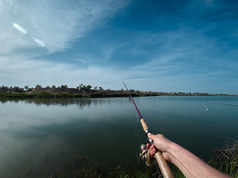Fisherman Casting into Tranquil Waters