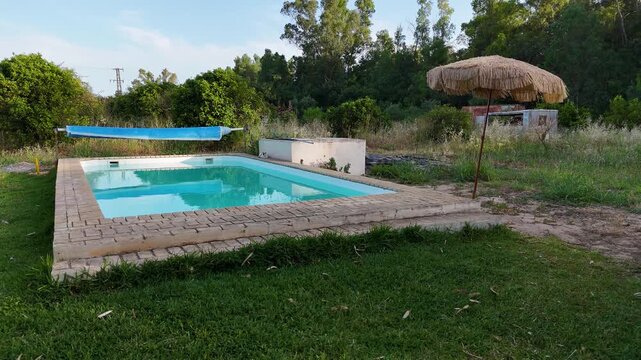 Rural swimming pool in a green backyard garden