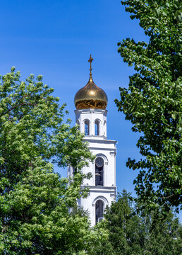View of the bell tower of the Iversky Monastery in Samara against a blue sky in summer