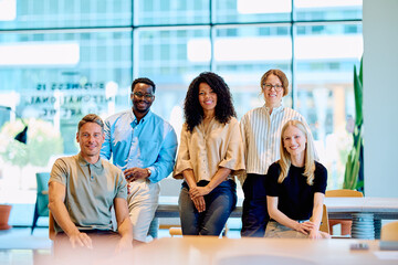 Diverse business professionals feeling positive and collaborating in a modern coworking office...