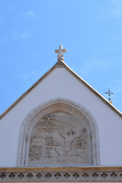 Neo-gothic architectural details showing a stone gable with a relief of Saint Francis receiving the stigmata on the church facade from the 19th century in Zagreb, Croatia