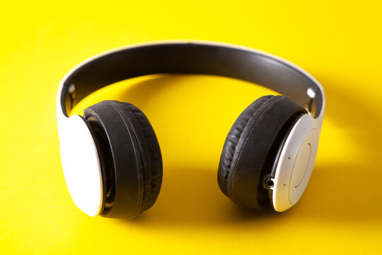 Headphones on a yellow background. Flat lay, top view.