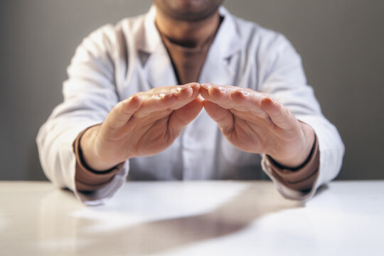 Close up of male doctor hands making stop gesture. Focus on hands.