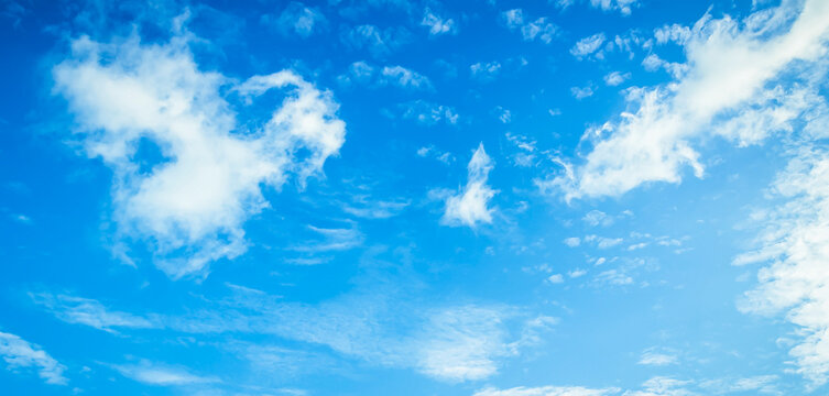 Beautiful vibrant blue sky background with colorful soft white clouds for inspirational nature wallpaper panorama mockup