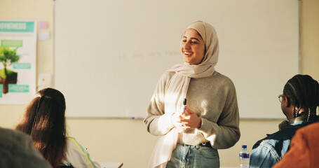 Education, muslim woman and teacher in classroom at high school with study tips, learning or smile....