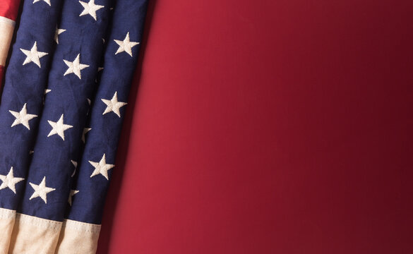 Happy Independence day concept made from American flag on dark red background.
