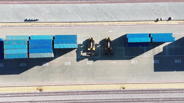 Moscow, December 30 2025, Aerial view of blue shipping containers labeled B2, B3, etc. Beige container stands next to them. Heavy truck moves near the containers. No people visible. Shows cargo