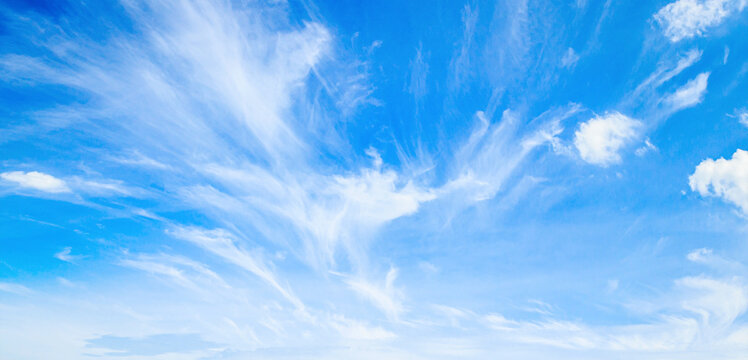 Beautiful vibrant blue sky background with colorful soft white clouds for inspirational nature wallpaper panorama mockup