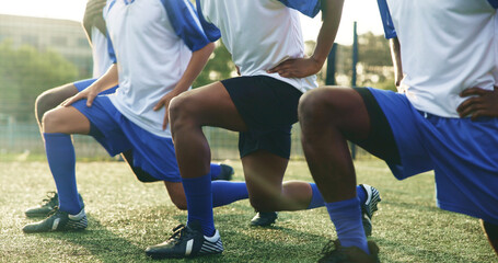 Naklejka premium Legs, soccer and stretching with men outdoor on field together for game or match start. Fitness shoes, sports and warm up with team of football players on grass pitch for competition or preparation