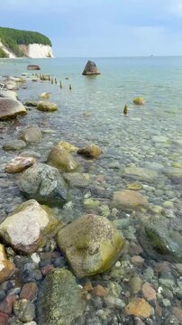 Famous white chalk cliffs and rocky Baltic Sea coastline in Jasmund National Park on Rugen island, Germany. Iconic natural landmark and coastal travel destination concept.