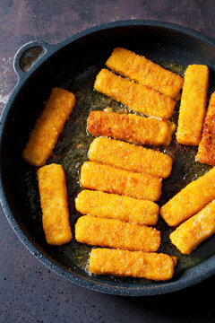 Fish fingers in frying pan