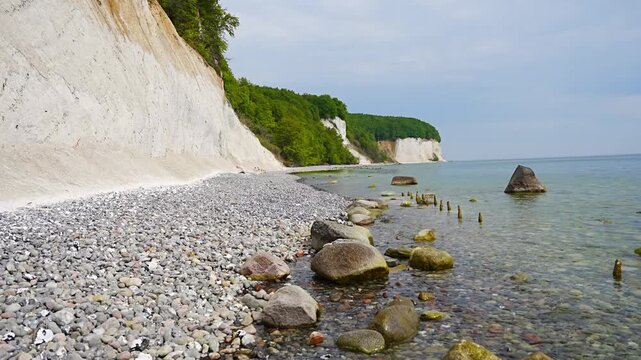 Famous white chalk cliffs and rocky Baltic Sea coastline in Jasmund National Park on Rugen island, Germany. Iconic natural landmark and coastal travel destination concept.