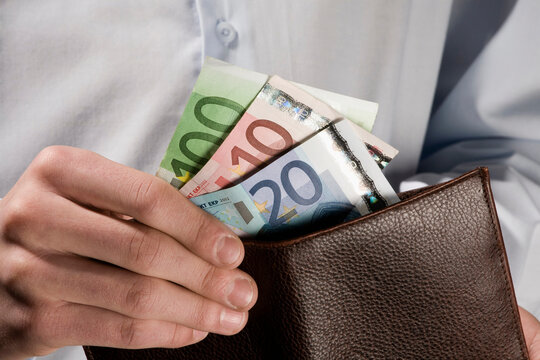 Person counting Euro notes, close-up