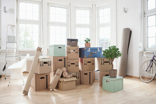 Stack of cardboard boxes in empty apartment
